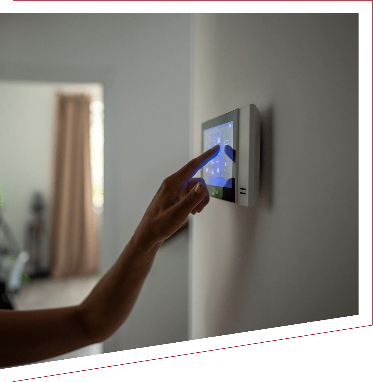Person adjusting a digital thermostat on a wall.