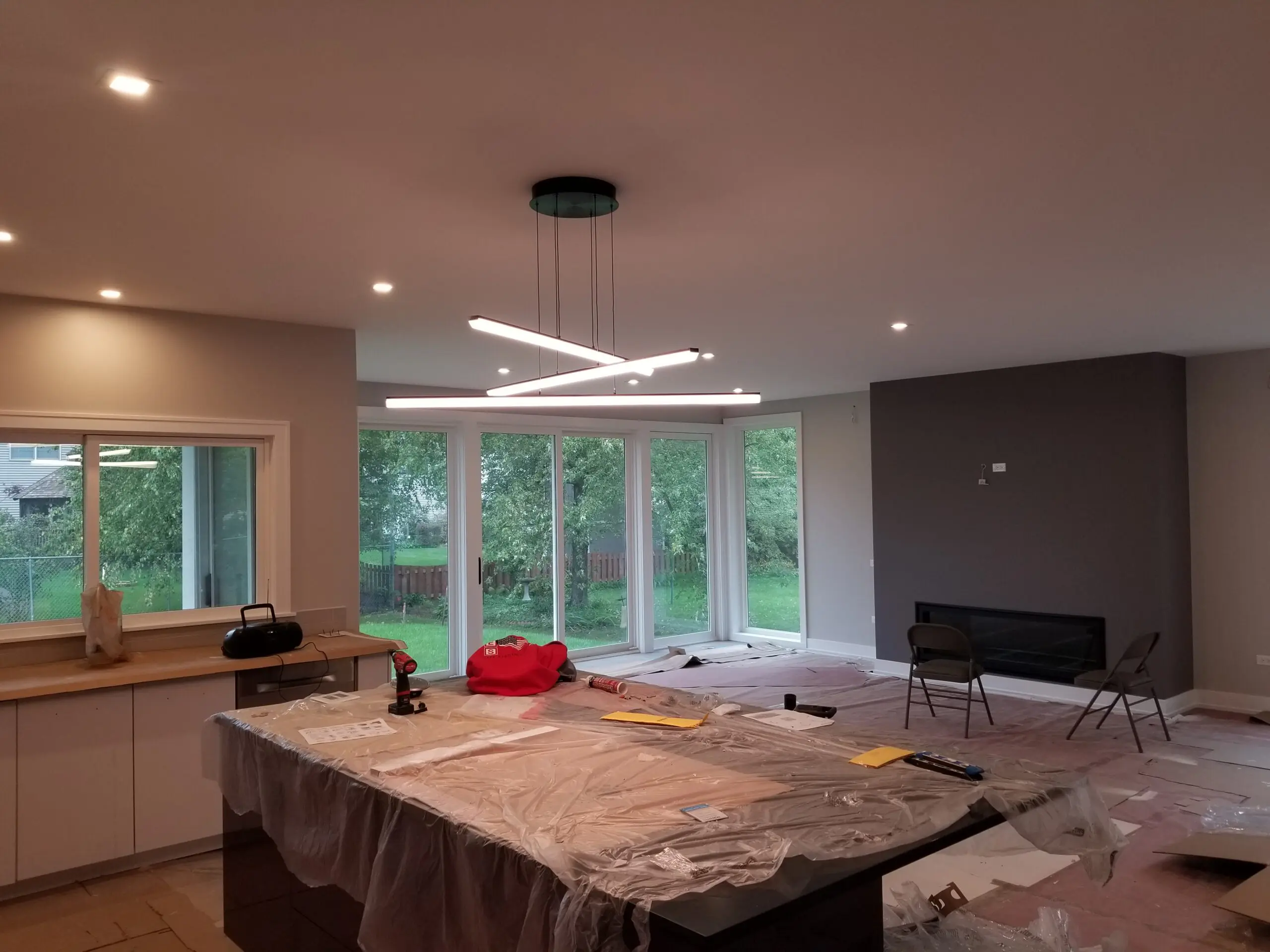 Modern dining room with large windows and contemporary lighting.