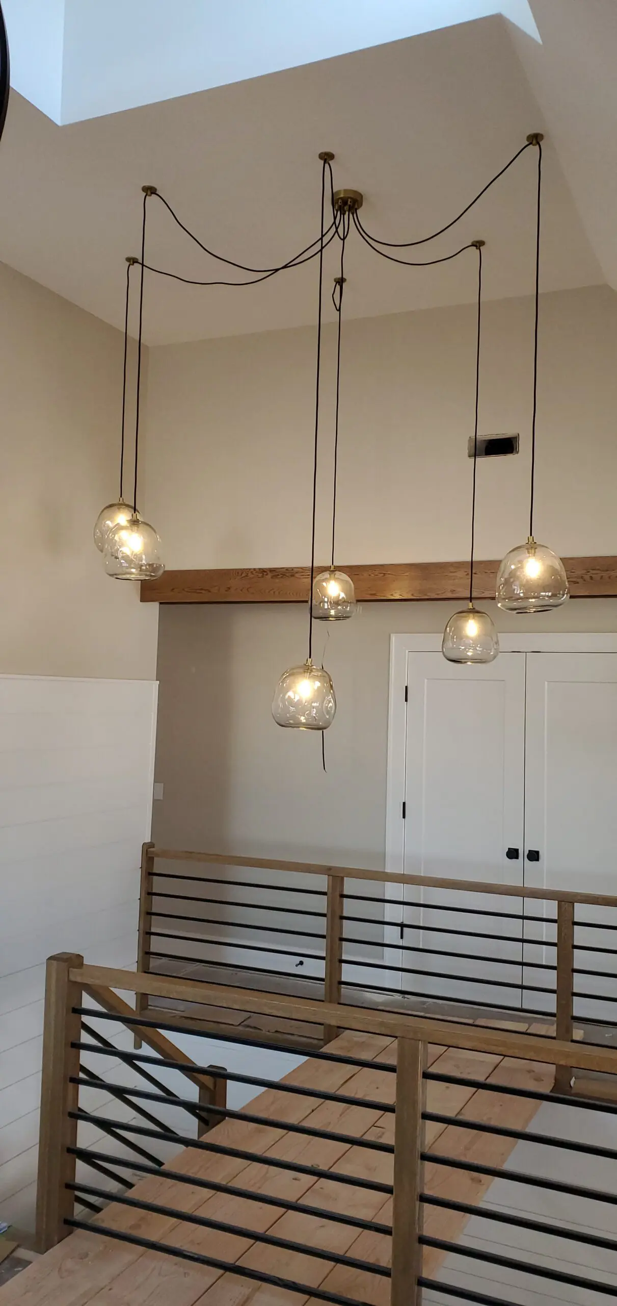 Modern pendant lights with spherical glass shades hanging from the ceiling.