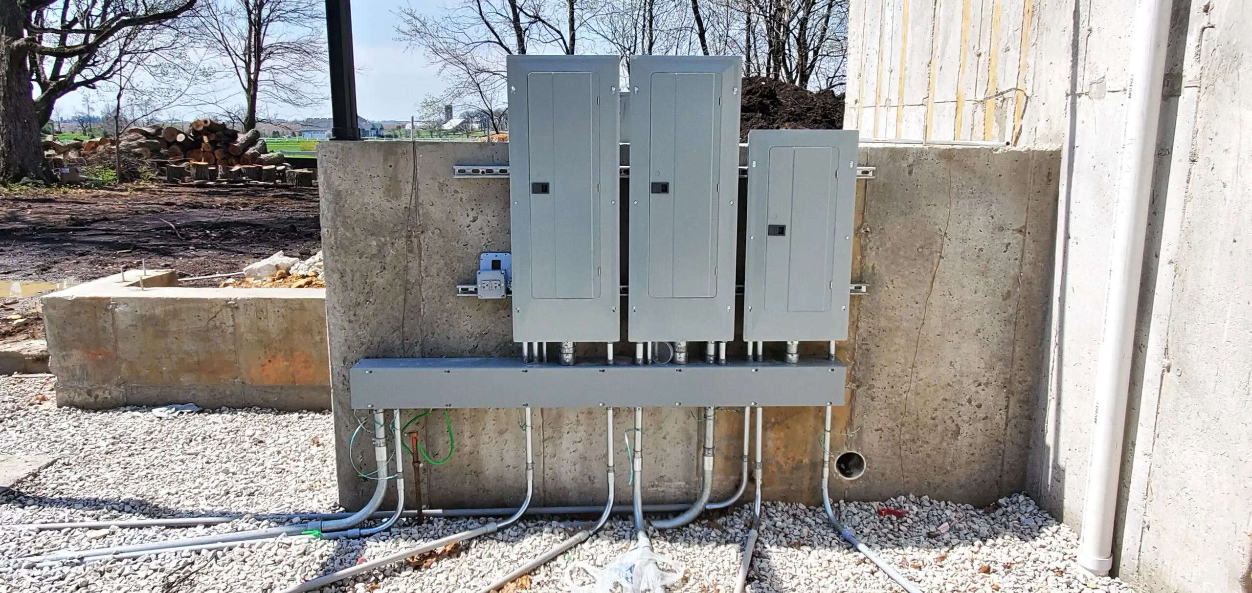 Electrical control panels installed outdoors with neatly organized conduit piping.