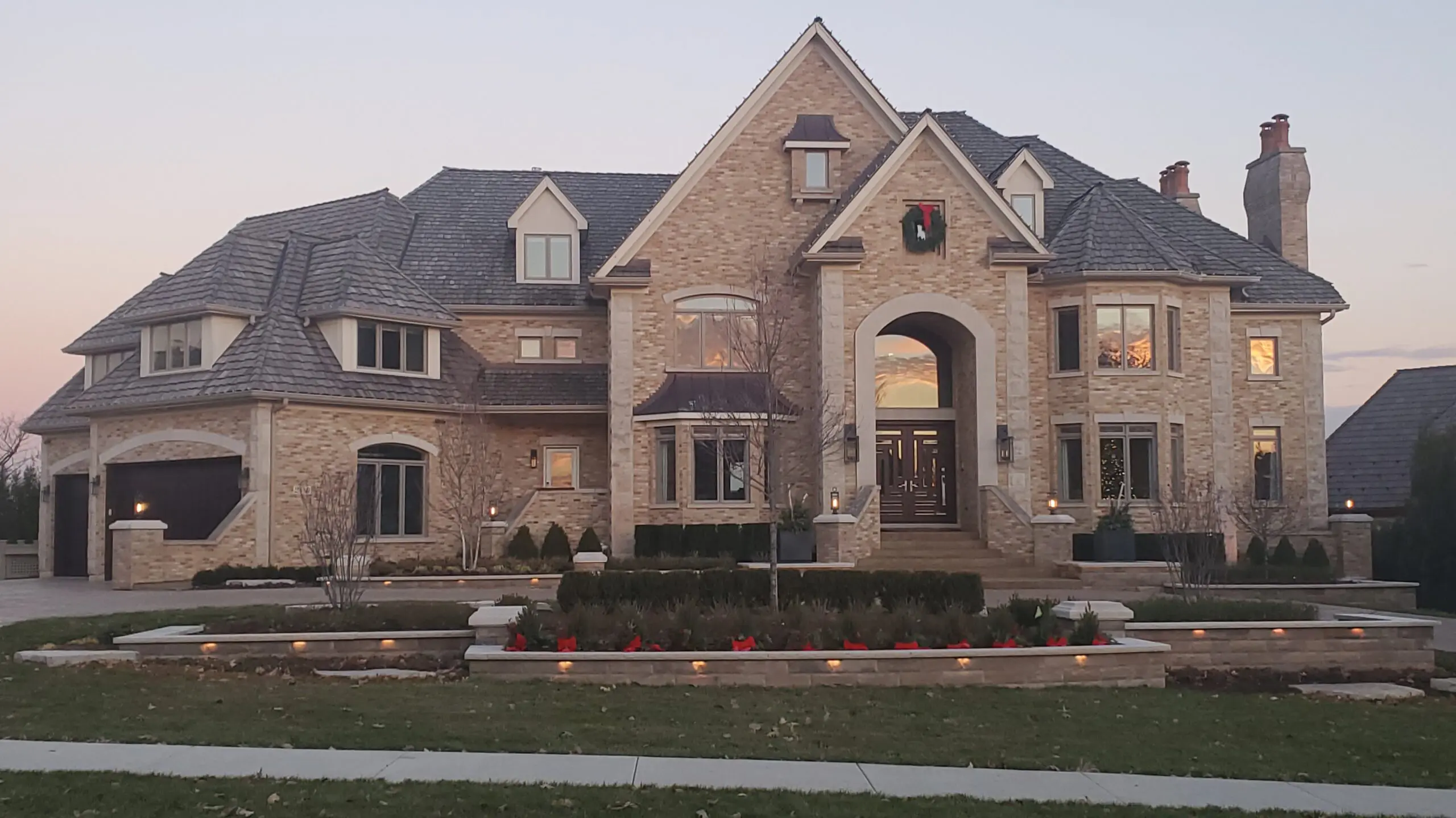 Large brick mansion with multiple windows and a grand entrance.