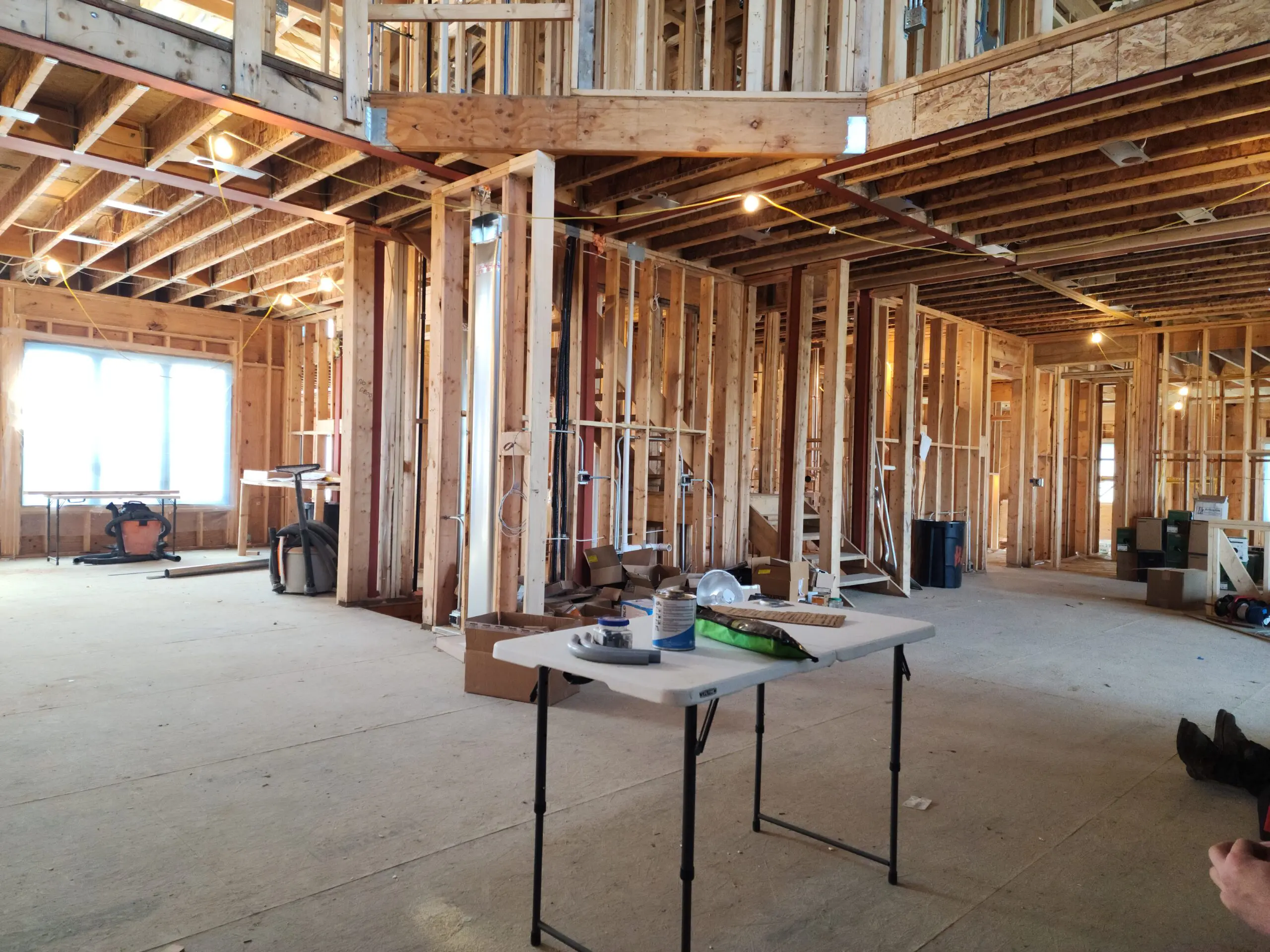 Interior of a house under construction showing exposed wooden framing.