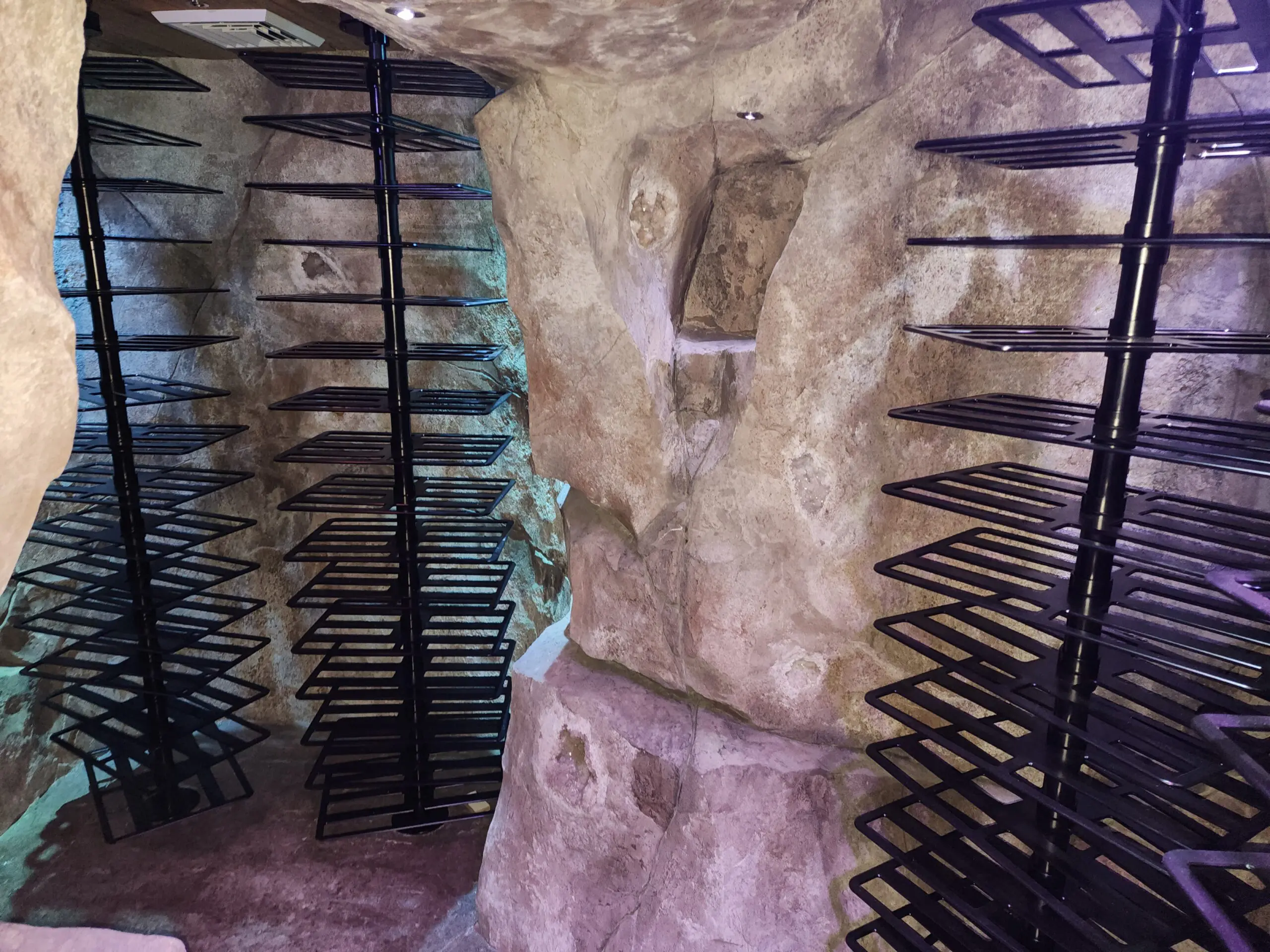 Ancient stone wall with iron bars and a small barred window.