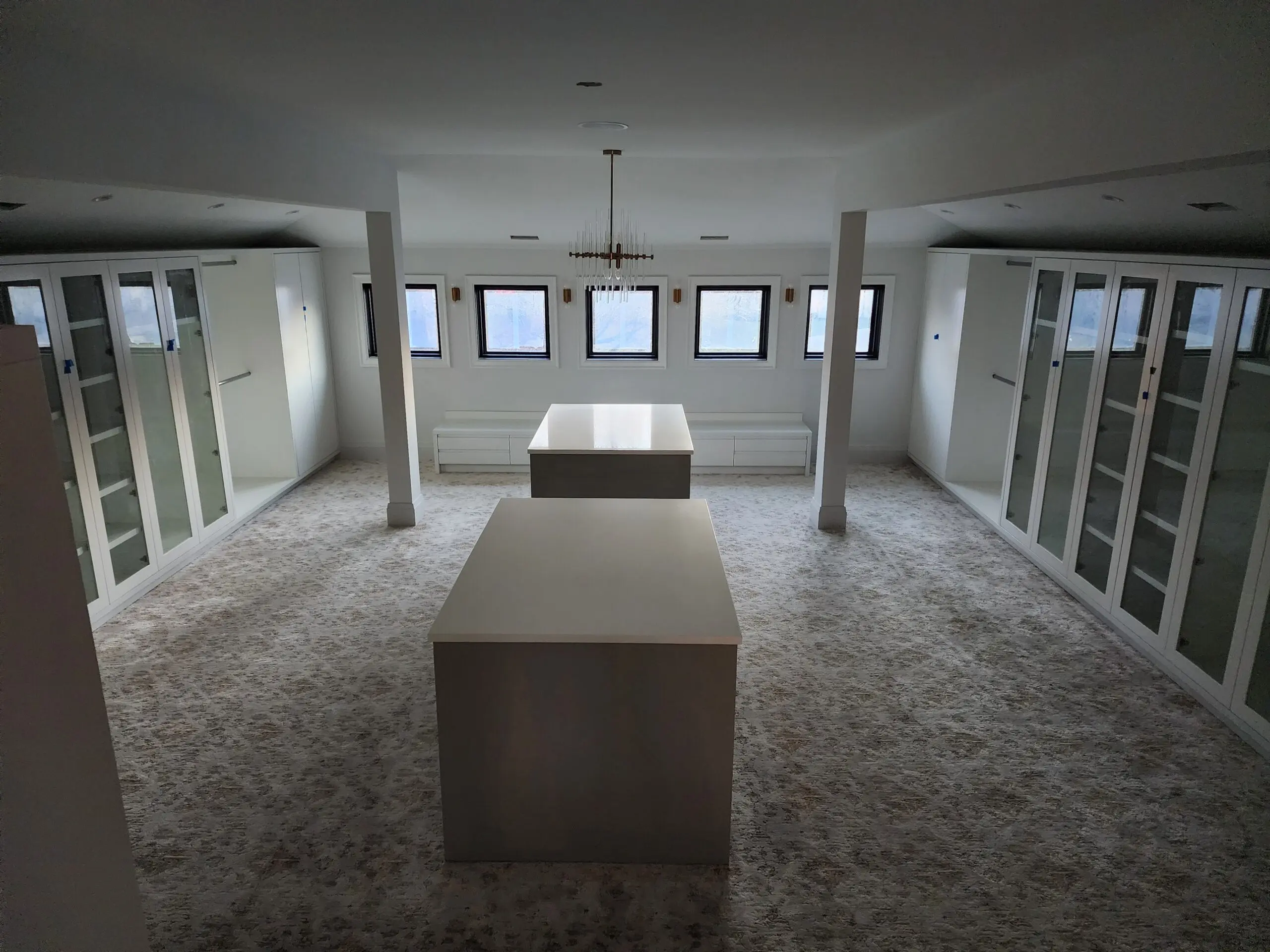 Empty room with tables and windows, featuring a modern and minimalistic design.