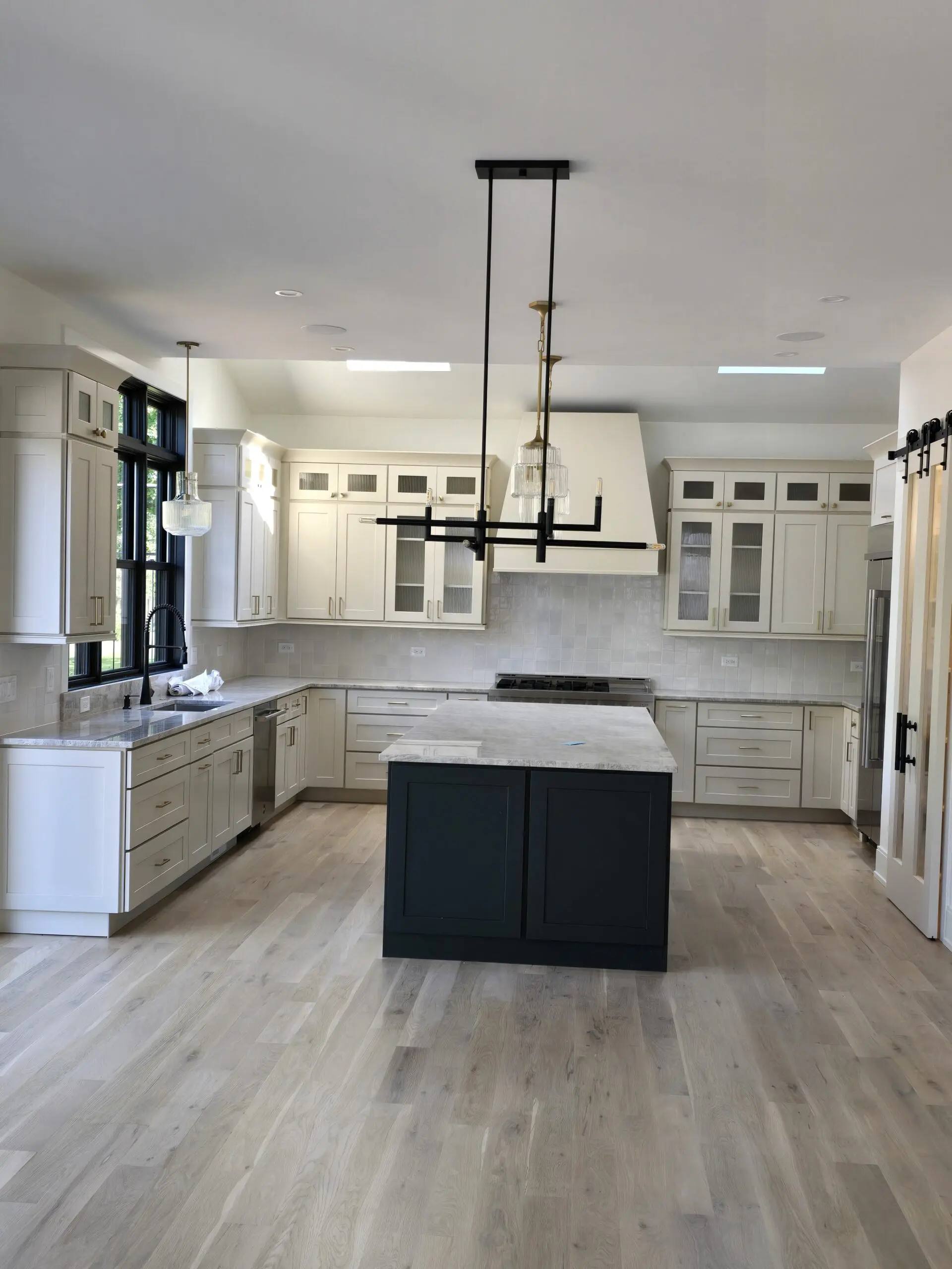 Modern kitchen with black and white contrast and large island.