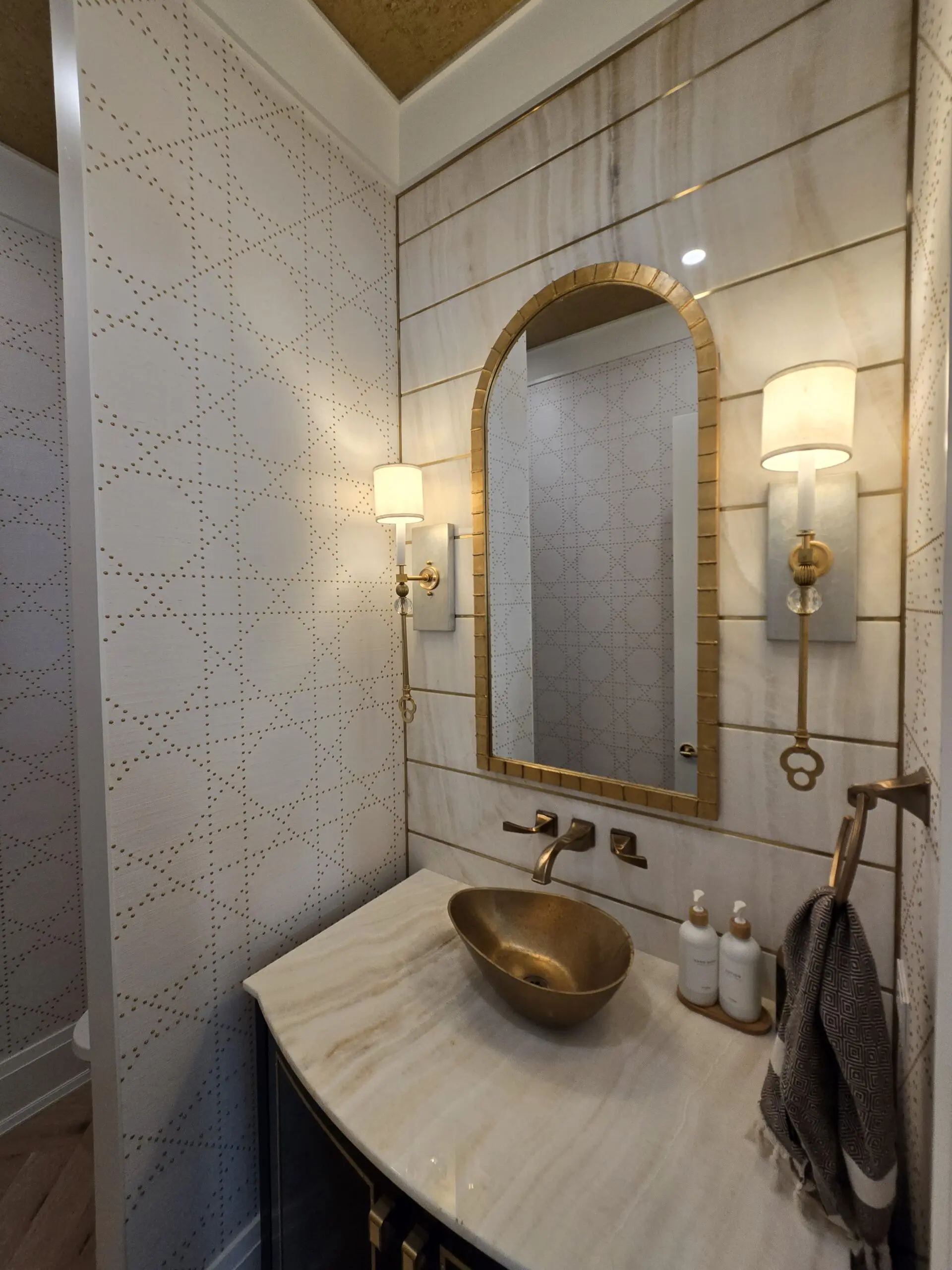 Elegant bathroom with gold fixtures and a unique bowl sink.
