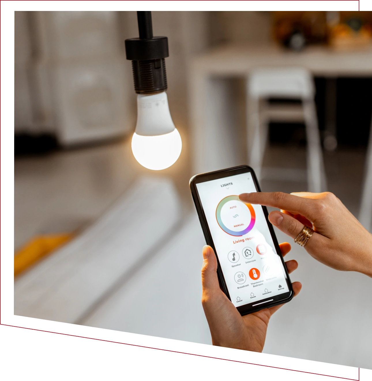 Smartphone controlling a dimmable LED light bulb.
